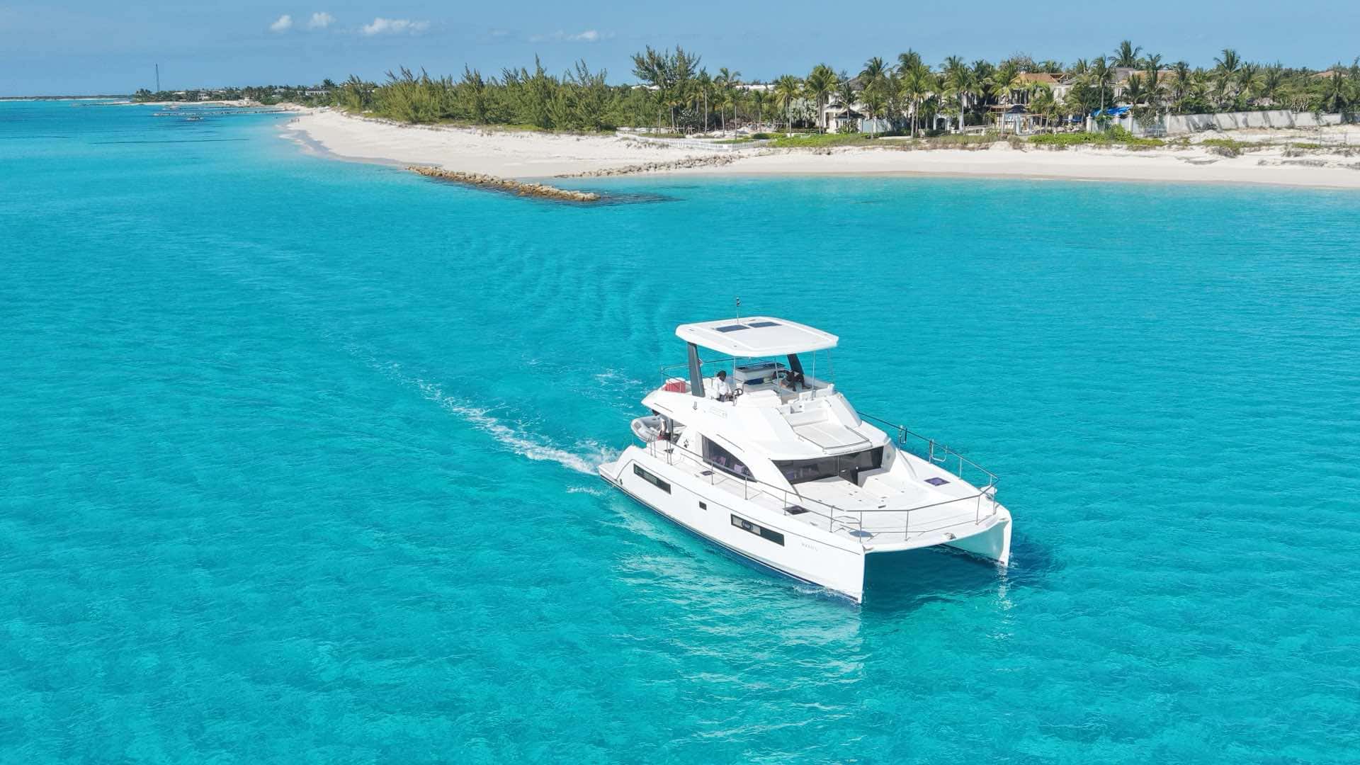 44ft luxury catamaran yacht cruising the turquoise water off Providenciales
