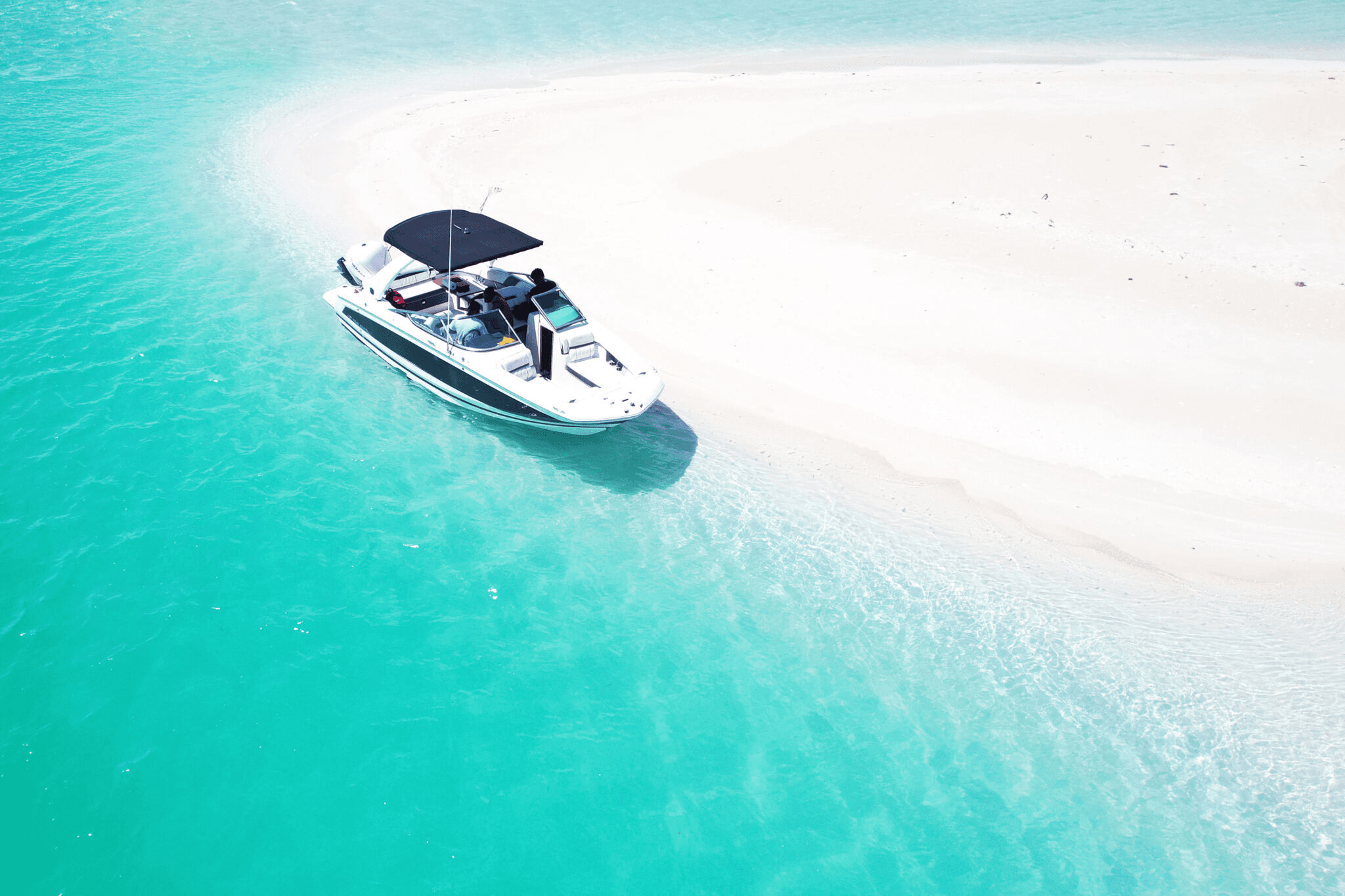 Shallow turquoise water over soft white sand in the Caicos Cays.